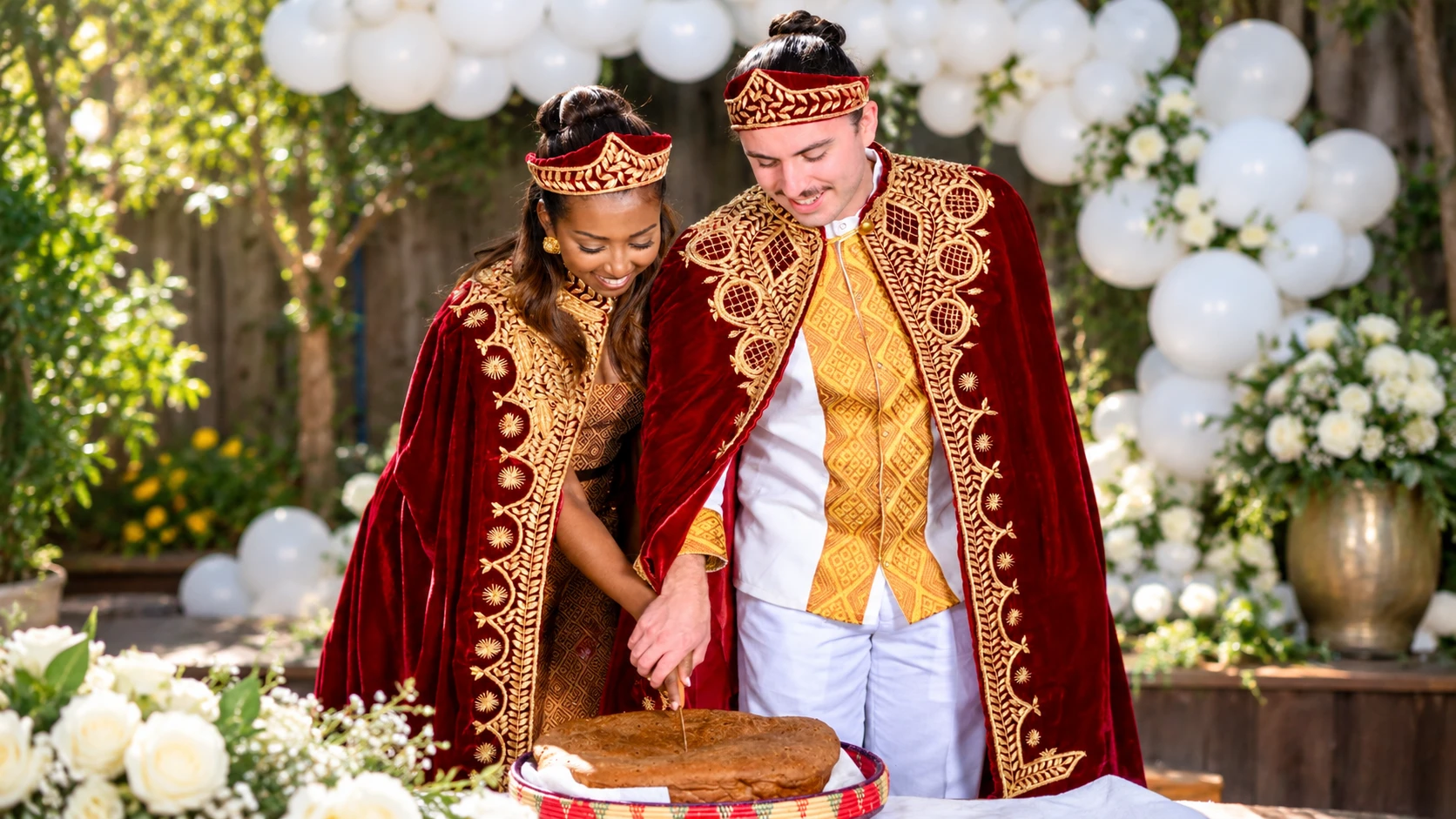 Mekaleya Tilahun and Raumin Neuville take part in a ceremonial bread cutting during their Ethiopian wedding celebration in San Ramon on October 11, 2026.