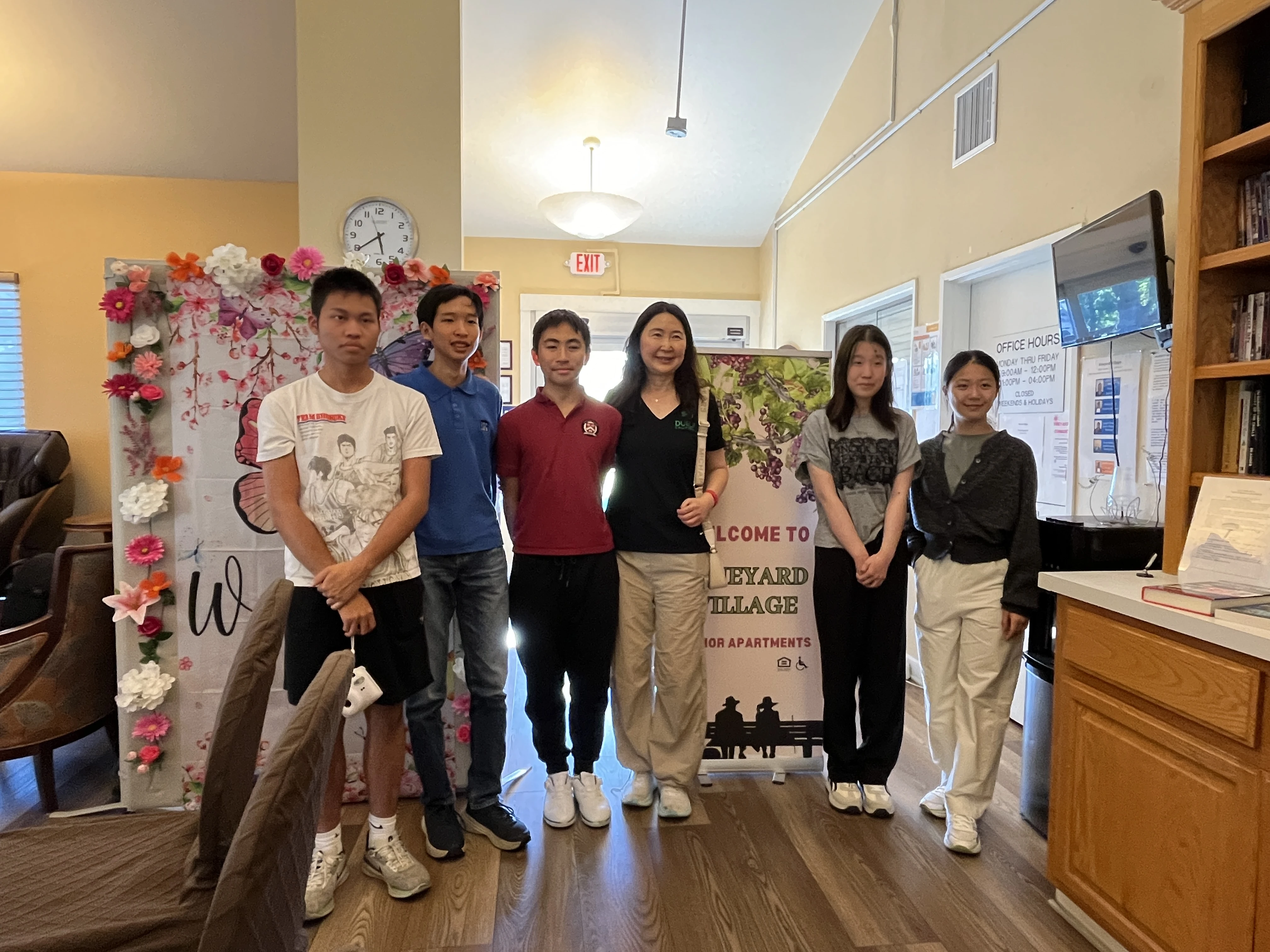 Dublin Mayor Sherry Hu joins AI Bridge founder Elliot Lu and student volunteers outside Vineyard Village in Livermore